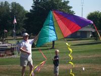 Sitka back pain free grandpa and grandson playing with a kite